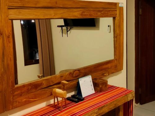 a mirror sitting on top of a wooden table at Balkondes Wanurejo in Borobudur