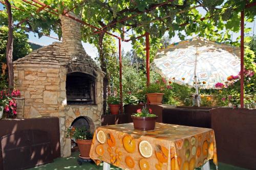 a patio with a table and a stone oven at Apartments Duda in Pula