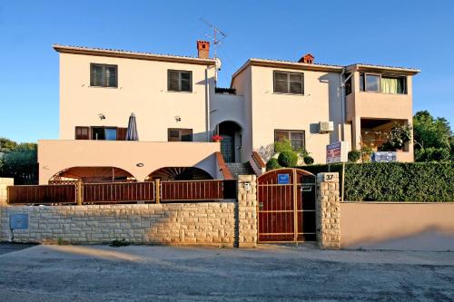 a house with a gate in front of it at Apartments Duda in Pula