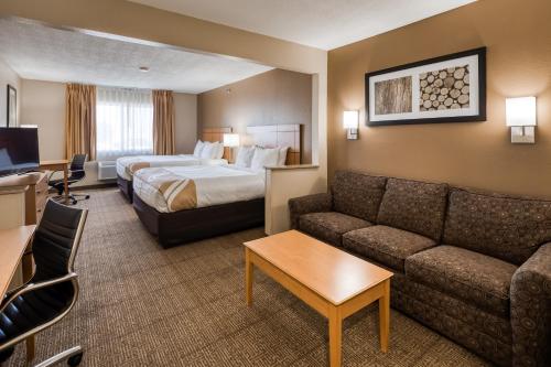 a hotel room with a bed and a couch at Quality Inn & Suites Springfield Southwest near I-72 in Springfield