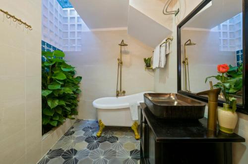 a bathroom with a sink and a bath tub at Hoi An Rosie Villa - 2 Bedrooms with Private Pool and Local Hoi An Decor in Hoi An