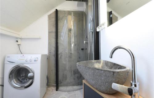 a bathroom with a sink and a washing machine at Ambjörby in Stöllet