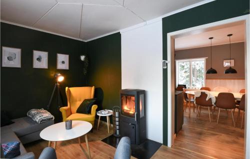 a living room with a fireplace and a dining room at Ambjörby in Stöllet