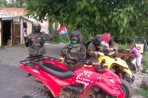a group of men sitting on a red dirt bike at Apartman & Sobe Orhideja in Smoljanac