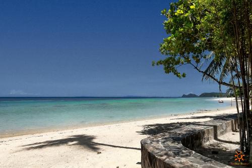 a shadow of a person on a beach at Sunshine Residence in Baan Tai