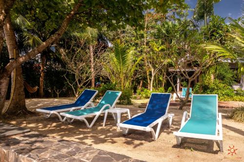 a group of blue and white chairs sitting in the sand at Sunshine Residence in Baan Tai