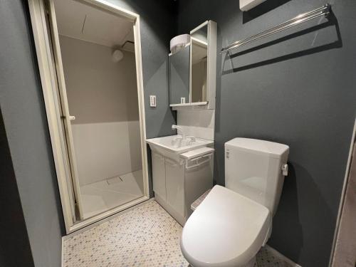 a small bathroom with a toilet and a shower at ZDT in Tokyo