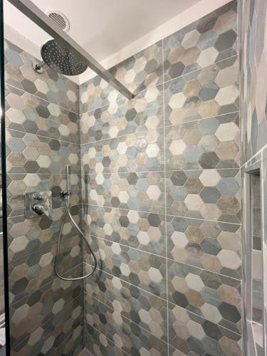 a bathroom with a shower with mosaic tiles at The Secret Garden in Salerno