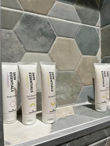 a group of four tubes of sunscreen sitting on a counter at The Secret Garden in Salerno