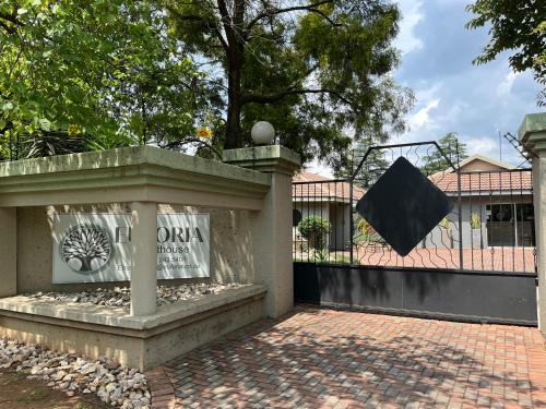 a sign on a fence in front of a building at Euforia Guesthouse in Middelburg