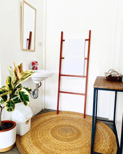 a bathroom with a rug on the floor next to a sink at Canna Boutique Hostel in Panglao Island