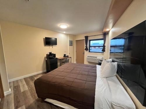 a bedroom with a large bed and a television at Circle Motor Lodge in South Amboy