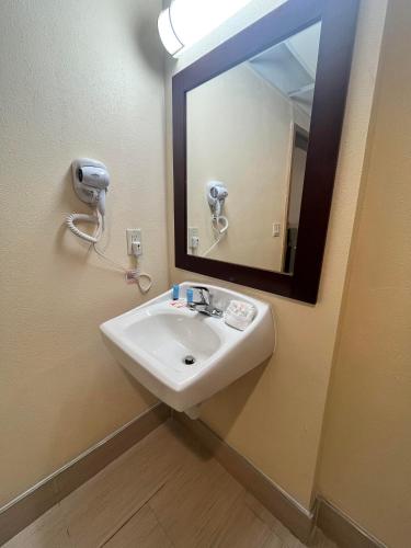 a bathroom with a sink and a mirror at Circle Motor Lodge in South Amboy