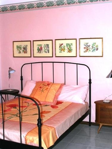 a bedroom with a bed with a metal head board at Camere In Centro in Agropoli