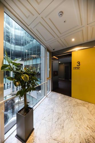 an office lobby with a potted plant in a yellow wall at LE SEOUL HOTEL in Seoul