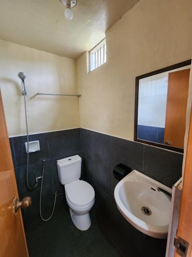 a bathroom with a toilet and a sink at Dam Dam Place in San Vicente