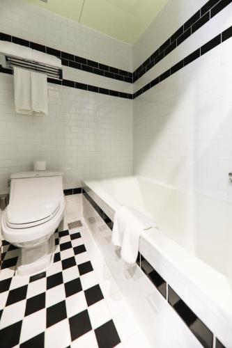 a bathroom with a black and white checkered floor at LE SEOUL HOTEL in Seoul
