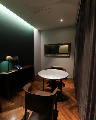 a room with a table and chairs and a mirror at LE SEOUL HOTEL in Seoul