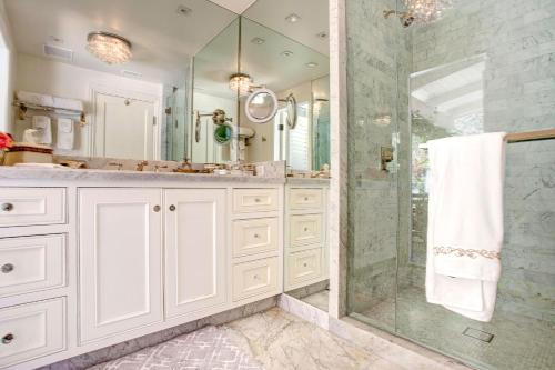 a white bathroom with a shower and a sink at Luxury Beverly Hills Suite in Beverly Hills