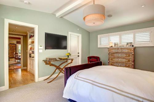 a bedroom with a bed and a flat screen tv at Luxury Beverly Hills Suite in Beverly Hills