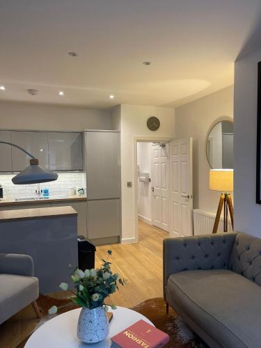 a living room with a couch and a table at Contemporary Residence by Salt Life in Brighton & Hove