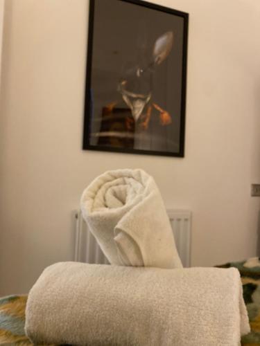 a pile of towels sitting on top of a bed at Contemporary Residence by Salt Life in Brighton & Hove
