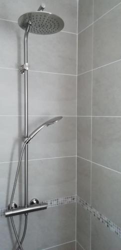 une douche avec pommeau de douche dans une salle de bain dans l'établissement côte et mer - appartement haut standing dans villa avec piscine et vue mer, à Taglio-Isolaccio