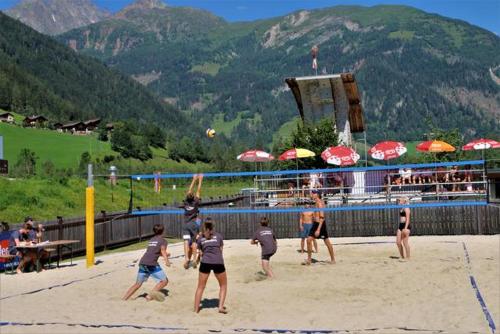 a group of people playing a game of volleyball on the beach at Apartment Haus Christina in Großkirchheim