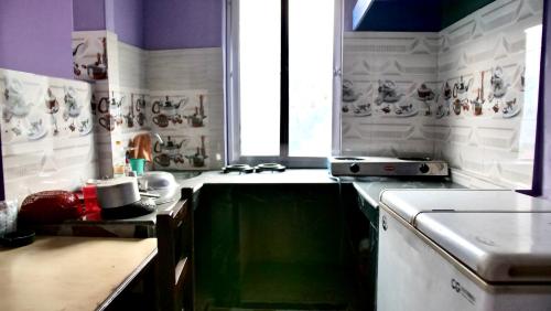 a kitchen with a table and a stove and a counter top at Fewa View Cottage and Yoga Retreat Homestay in Pokhara