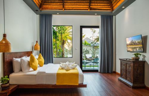 a bedroom with a bed and a view of a patio at Le Chanthou Boutique in Siem Reap
