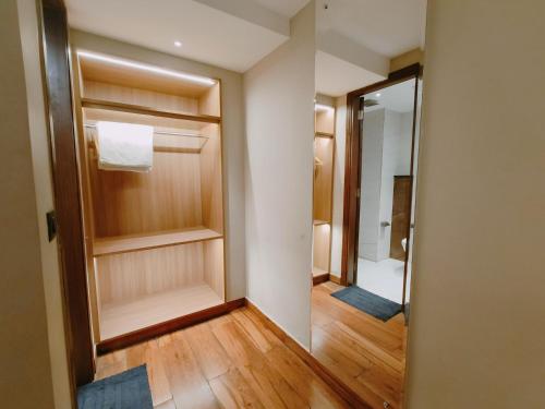 a bathroom with a walk in shower and a mirror at Aura Rooms in Dehradun