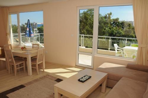 a living room with a couch and a table at Yassen Holiday Village in Sunny Beach