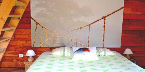 a bedroom with a bed with a rope bridge at Chambres d'Hôtes Le Nid d'Iroise in Lanildut
