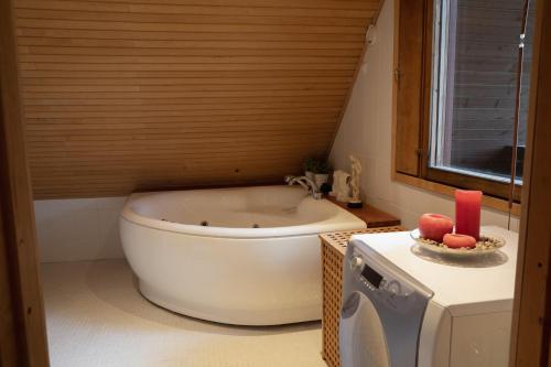 a bathroom with a bath tub and a sink at Villa Jupperi Espoossa in Espoo