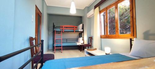 a bedroom with a bed and a room with a ladder at Anchialos seafront appartement in Nea Anchialos