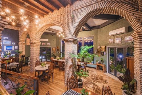 a restaurant with a brick wall and tables and chairs at Nuuk Taal Lake in Laurel