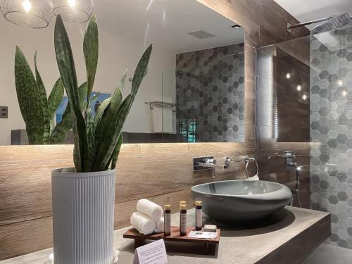 a bathroom with a sink and a vase with a plant at Nuuk Taal Lake in Laurel