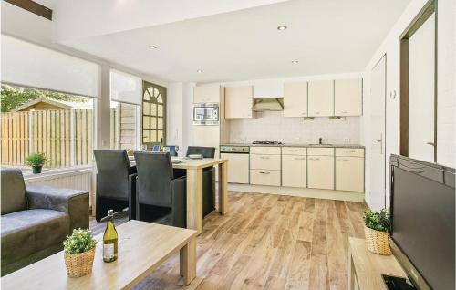 a kitchen and living room with a couch and a table at Oud Kempen Bungalow 37 in Stavenisse
