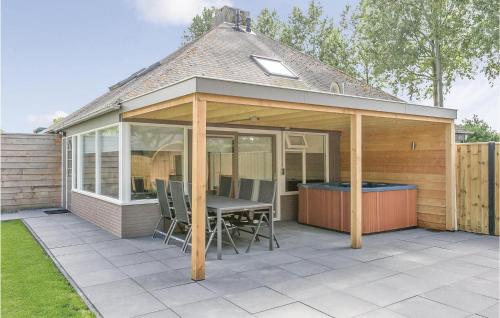 a pavilion with a table and chairs on a patio at Oud Kempen Bungalow 37 in Stavenisse