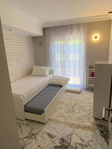 um quarto com uma cama e uma parede de tijolos em Belek,te turizm,golf,tenis ve futbol em Belek