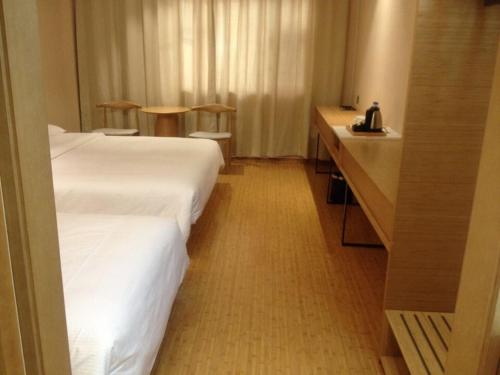 Łóżko lub łóżka w pokoju w obiekcie Ji Hotel Zhuhai Gongbei Branch