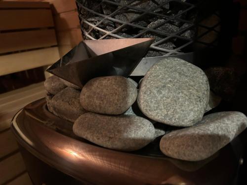 a pile of rocks sitting on top of a bowl at Romantic cozy house Kirzacinas pirts with sauna close to seaside in Skulte