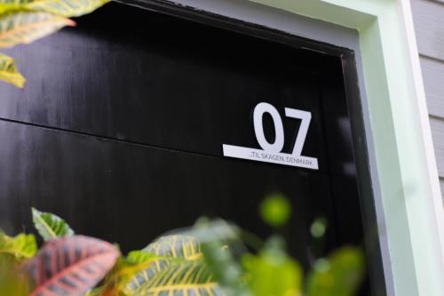 a sign for a house with the number on it at Nuuk Taal Lake in Laurel
