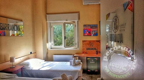 a bedroom with a bed and a desk and a window at B&B&Beer in Cassano delle Murge