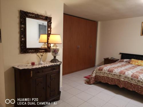 1 dormitorio con cama y espejo en la pared en APE REGINA Morlupo extension en Morlupo