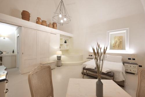 a bedroom with a bed and a table and a tub at Dimora San Giuseppe in Lecce