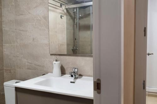 a bathroom with a sink and a mirror at Apartamento en primerisima linia de playa in Oropesa del Mar