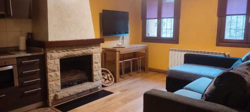 a living room with a couch and a fireplace at AlaiSuberri in Oronz