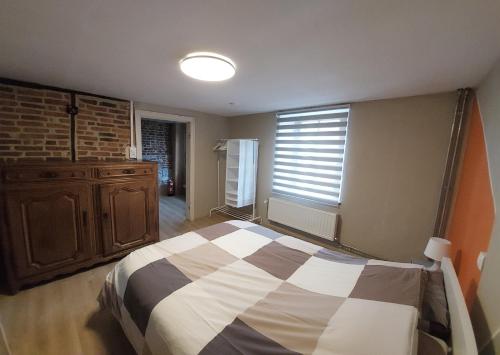 a bedroom with a bed and a window at La Rustique in Dinant