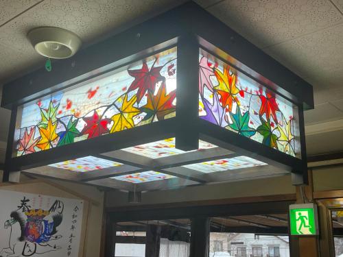 a large stained glass window in a building at Tsuyukusa in Takayama